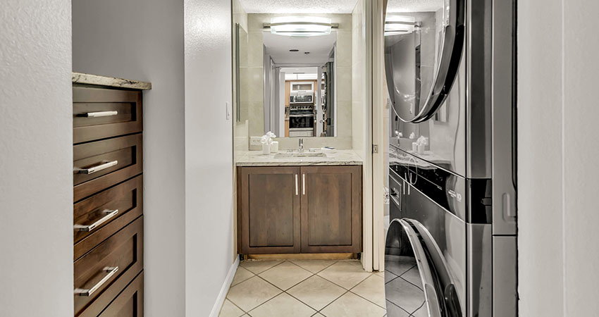 Veranda Beach Club of Longboat, master bathroom with a stackable washer and dryer combo